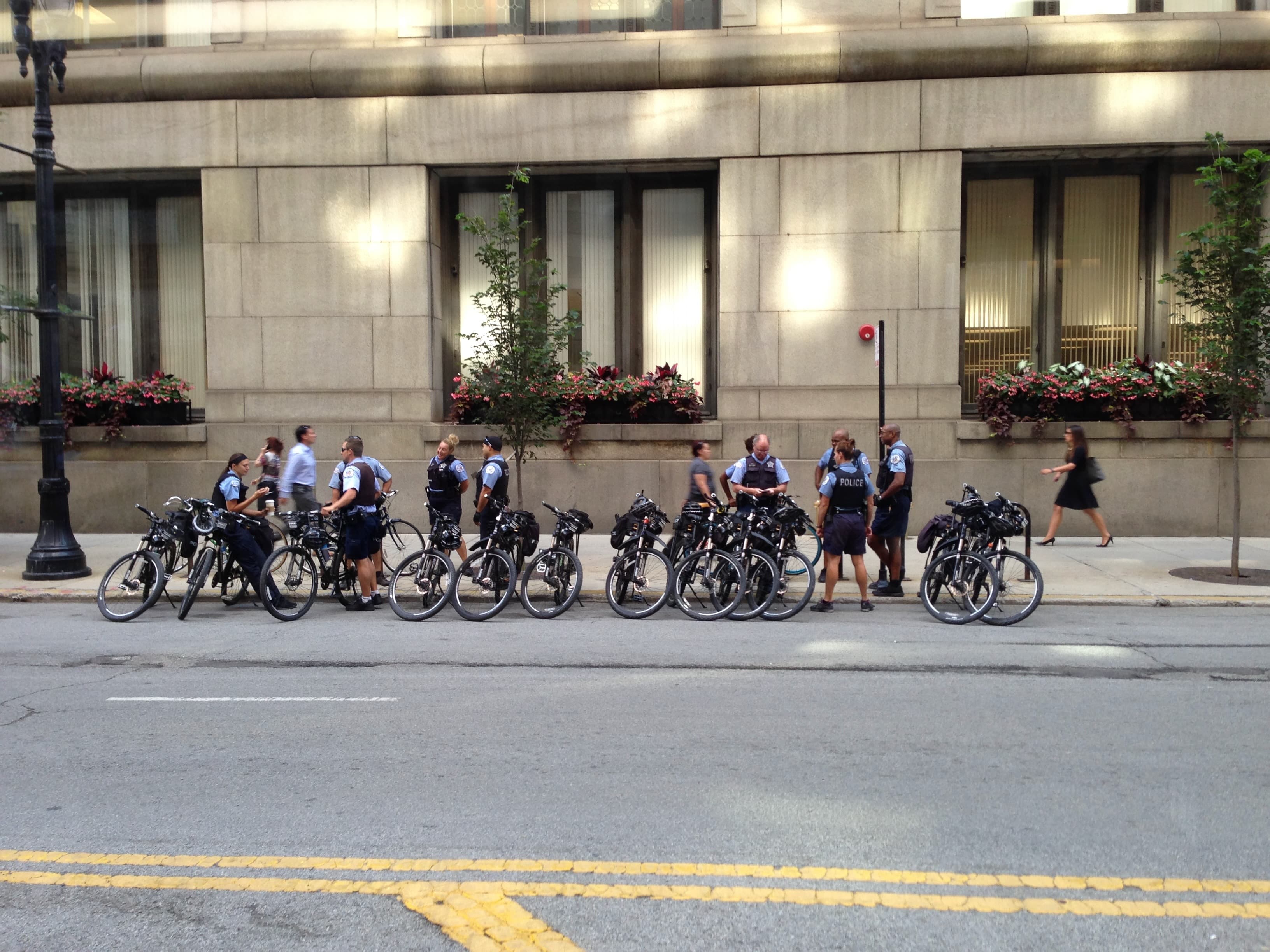 Urban Bike Patrol - Police officers on bicycles pause during their pat...